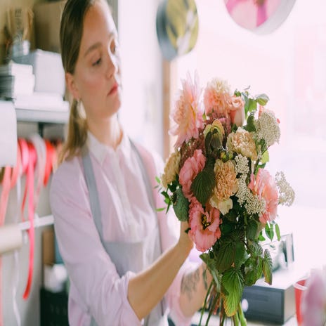 Mulher arruma buquê de flores em francês
