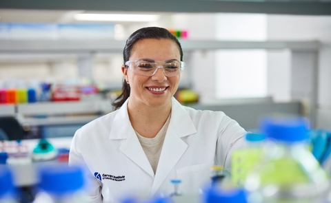 female researcher wearing safety glasses in a lab