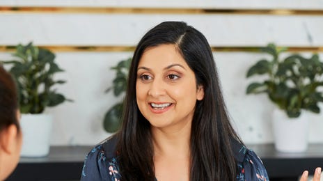Instructor smiling and talking to her student in a foreign language during their private language course with Berlitz Saudi Arabia