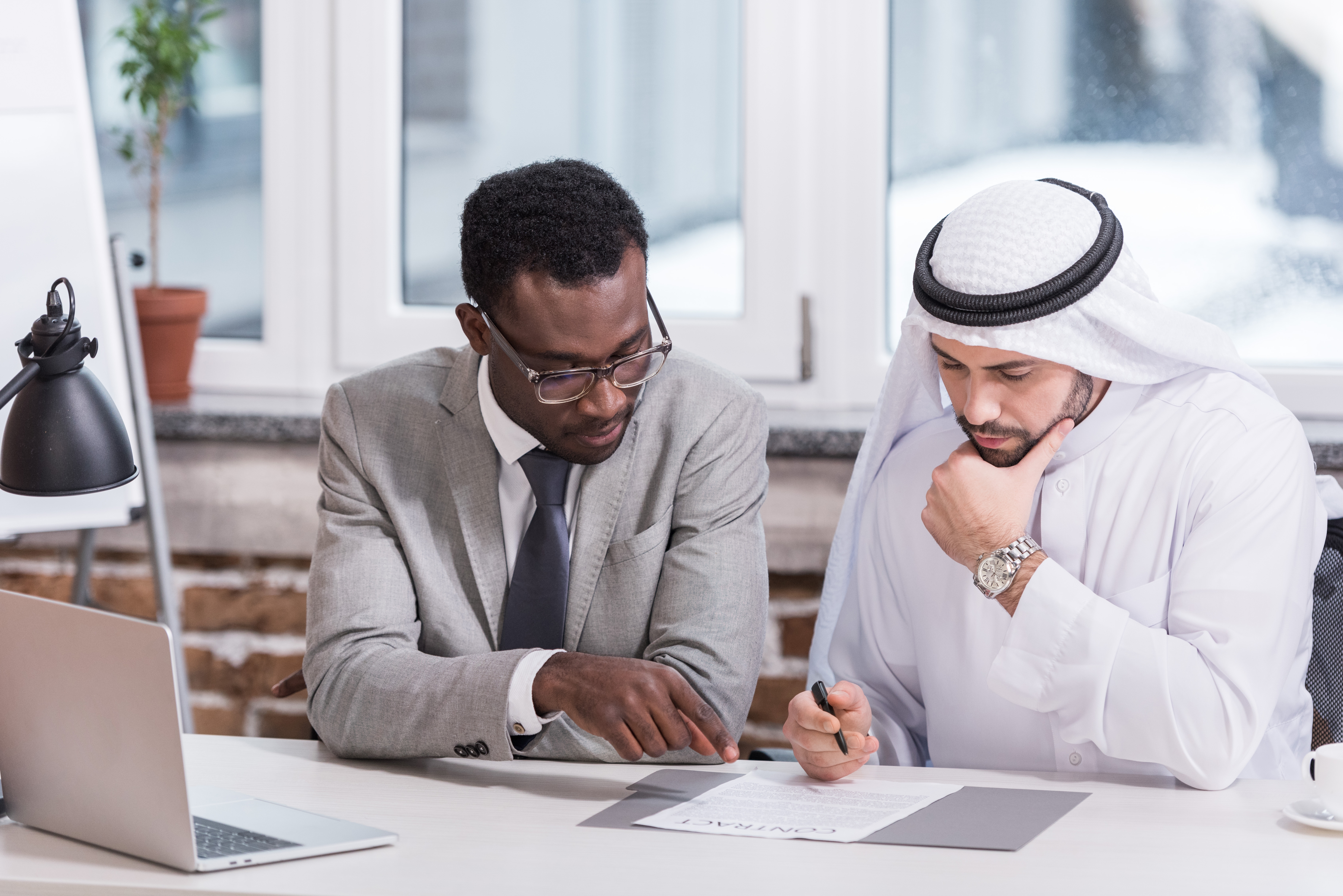 Student and instructor looking at an exercise during one of their private language lessons with Berlitz Saudi Arabia