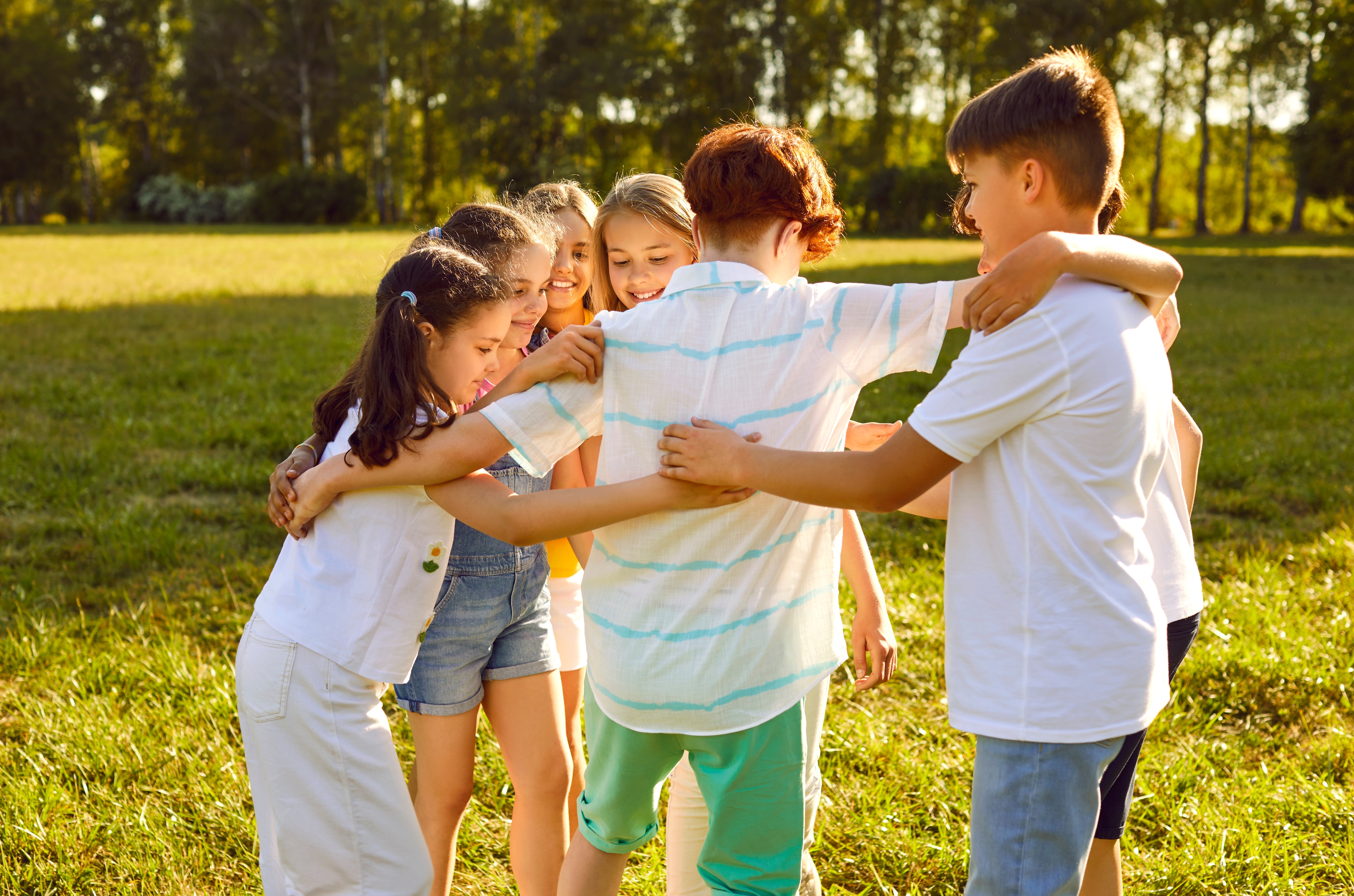 Kids in a field playing with each other during their summer language camp for kids and teens with Berlitz Saudi Arabia