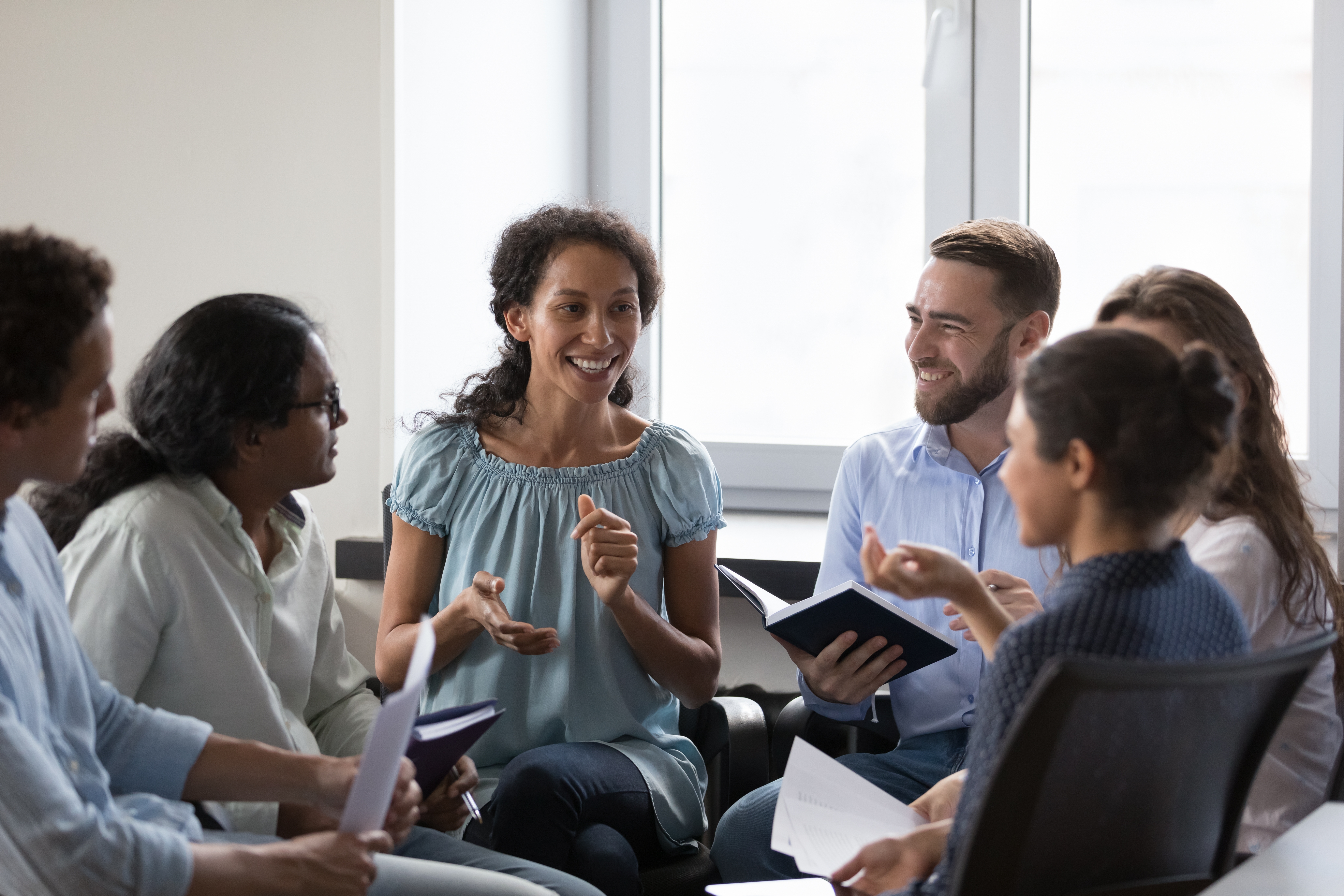Instructor talking to her students who are attending her class to learn a foreign language