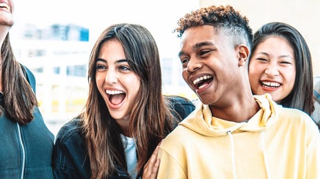 A group of teens chatting and laughing after their Spanish language lesson for kids and teens with Berlitz
