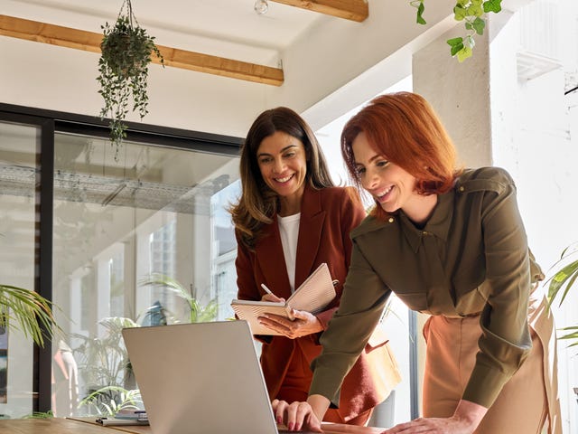 two women in their workplace preparing for a presentation in German using the skills they learned in Berlitz's German language classes