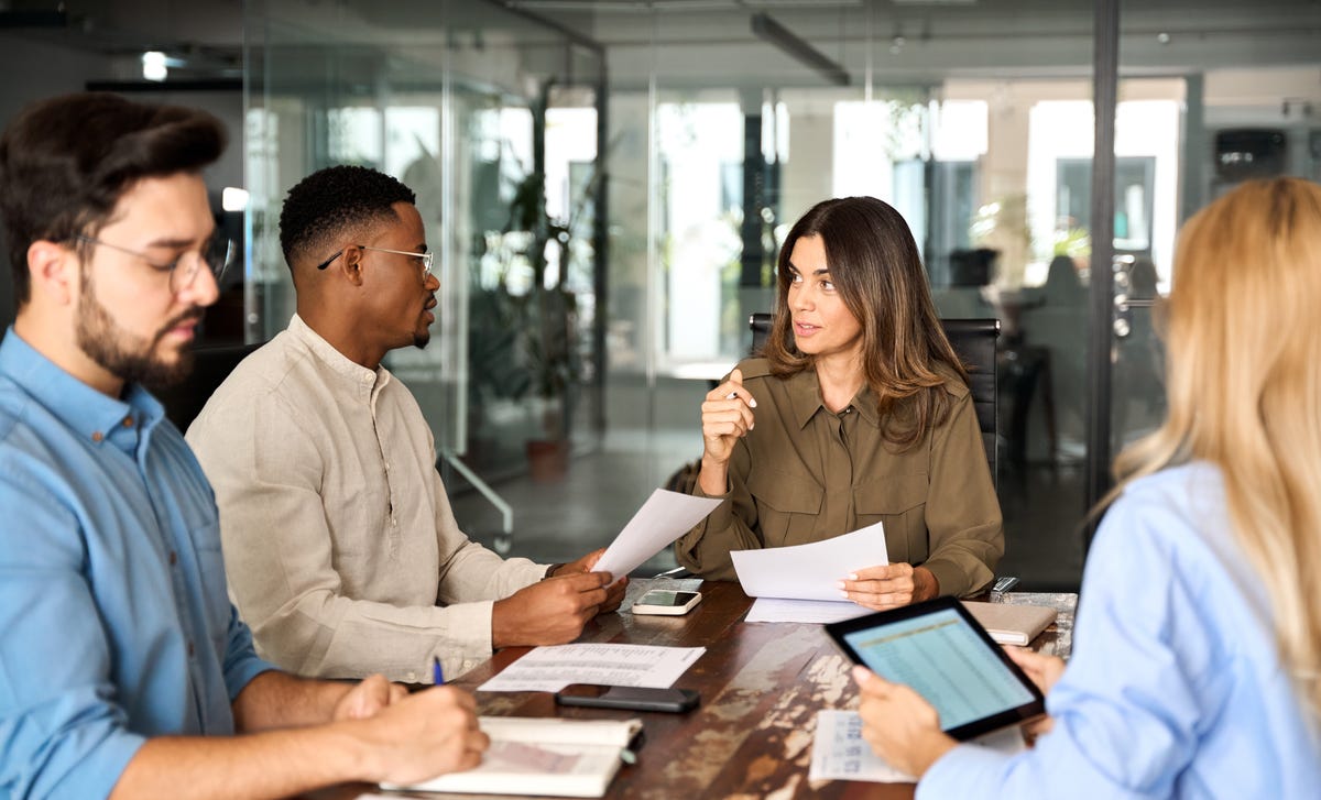 Instructor talking to her students during a business seminar