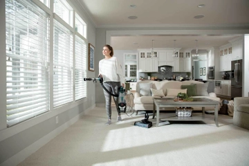 Using pod of vacuum with hose and extension wand to vacuum above floors