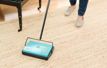 Refresh Manual Sweeper sweeping area rug. 