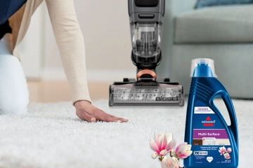 Running hand over carpet with CrossWave and multi-surface formula bottle nearby