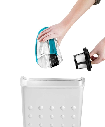 Emptying Dirt Bin from Pet Hair Eraser Hand Vac into trash. 