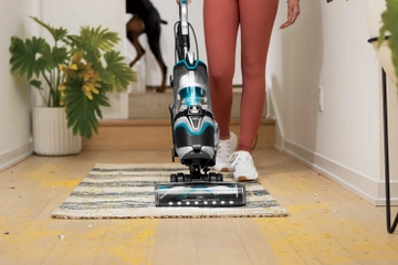 Using SurfaceSense Vacuum Cleaner to vacuum area rug. 