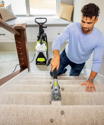 Using tool on end of hose of Big Green PET PRO Carpet Cleaner to deep clean stairs.