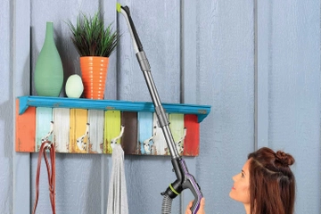 Using Extension wand on hose with tool to vacuum areas above flooring.