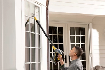 Using PowerSteamer with extension wand to steam clean windows above flooring
