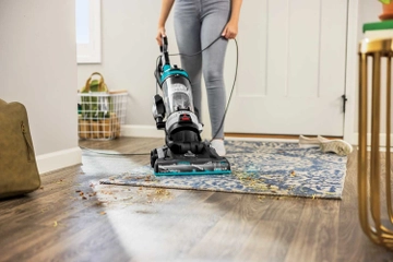 CleanView Rewind Vacuum dirt from area rug in entry way