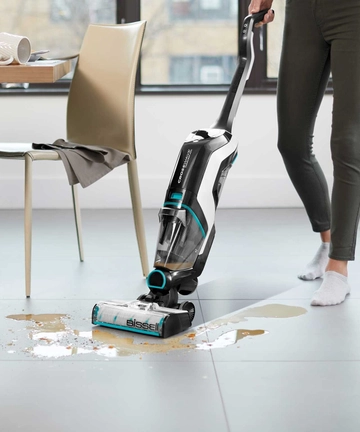 CrossWave Cordless Max Multi-Surface Wet Dry Vac vacuuming and mopping up spilled mess on tile floors.