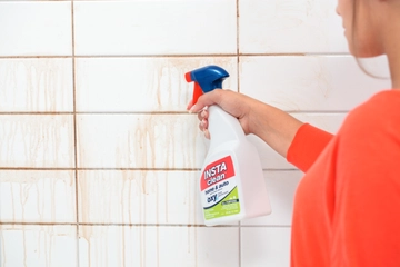 INSTAclean Stain & Odor Remover cleaning shower grout and tiles.