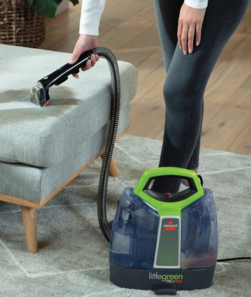 Little Green ProHeat Portable Cleaner cleaning stain off couch.