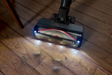 Headlight feature vacuuming hair and dirt from hard flooring