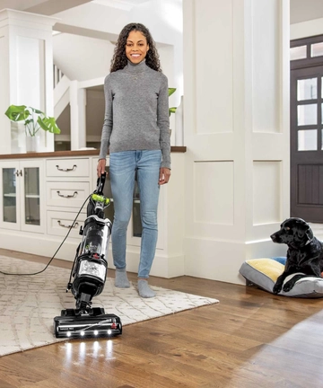 MultiClean Allergen Pet Slim Vacuum vacuuming from carpet to hard floor using swivel feature.