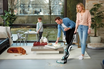 Using CrossWave Cordless Max Wet Dry Vac in living area with hard floors and area rug.