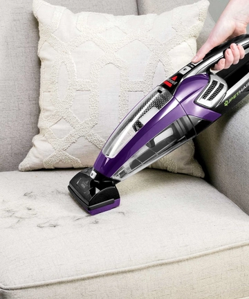 Using Motorized Brush to remove pet hair from couch cushion 