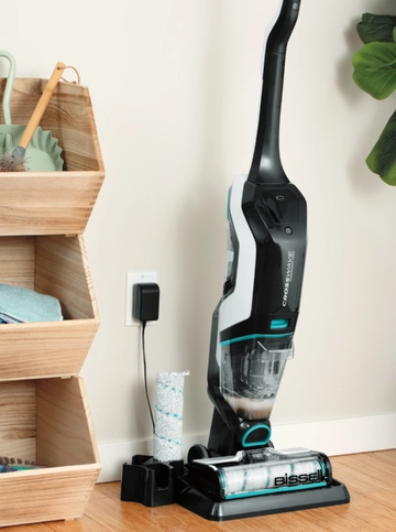 CrossWave Cordless Max charging with CrossWave brush next to it on hard flooring.