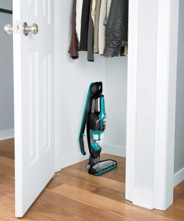 ReadyClean Cordless Stick Vac Handle Folded and machine stored in closet