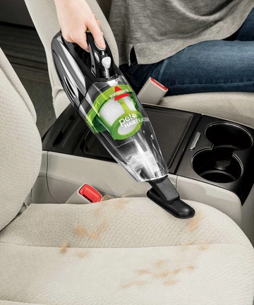 Pet Hair Eraser Hand Vac Vacuuming Car interior.