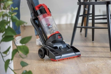 CleanView Compact Vacuum vacuuming crumbs from hard flooring.