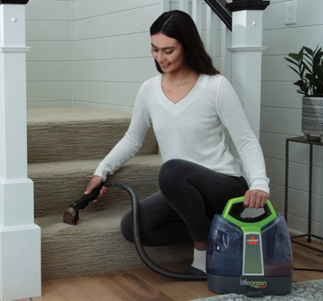 Little Green ProHeat Portable Cleaner cleaning stairs.