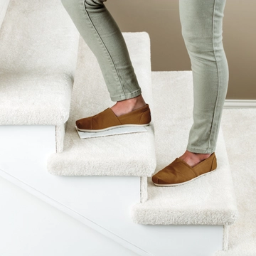 Stomp 'n Go® Pet Stain Lifting Pads being used to lift stain off carpeted stairs.
