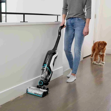 CrossWave Cordless Max Multi-Surface Wet Dry Vac vacuuming pet hair along baseboard.    