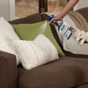 Woolite® Free & Clear Pet Stain & Odor Remover Pretreat being sprayed on pillow.