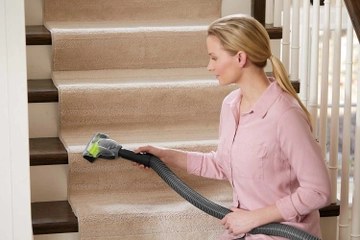 Using Pet TurboBrush on hose to vacuum stairs.