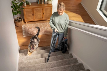 Using Pod with hose and tool to vacuum carpet on stairs