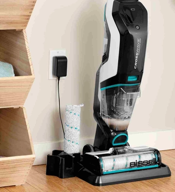 CrossWave Cordless Max Multi-Surface Wet Dry Vac on storage cleaning try with brush roll in holder. 