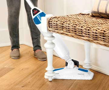 PowerFresh Steam Mop Steaming hard flooring under furniture.