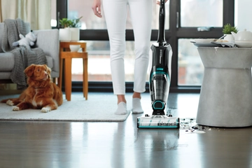 CrossWave Cordless Max cleaning up wet mess off hard flooring in living room.