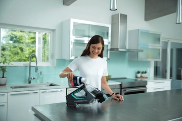 Pet Stain Eraser PowerBrush being refilled with cleaning formula.