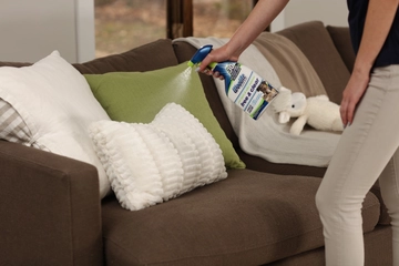 Woolite® Free & Clear Stain & Odor Remover Pretreat being sprayed on pillow.