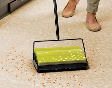 REFRESH Manual Sweeper picking up crumbs off rug.
