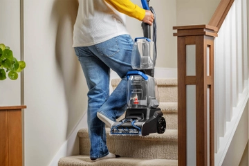 Carrying TurboClean Pet Carpet Cleaner upstairs