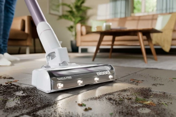 PowerClean Stick Vac vacuuming dirt from tile flooring