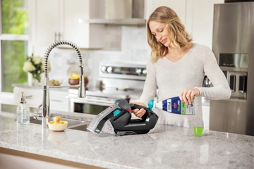 Pet Stain Eraser being filled with cleaning formula.