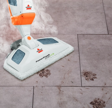 PowerFresh Pet Lift-Off 2-in-1 Steam Mop Steaming dirty pet paws from tile floors.