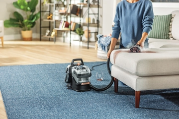 Using Little Green HydroSteam Portable Carpet Cleaner to clean wine stain off chair cushion.