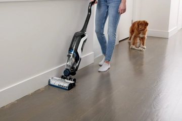 CrossWave Cordless Max Multi-Surface Wet Dry Vac vacuuming pet hair along baseboard.    