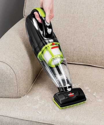 Using Motorized Brush Of Pet Hair Eraser Hand Vac to vacuum couch cushion