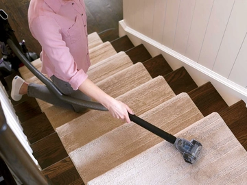 Using Pet TurboEraser Tool on end of hose to vacuum stairs.