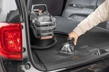 Little Green HydroSteam Portable Cleaner cleaning car upholstery.